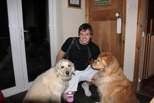 Elliot with family pets, golden retrievers Lily, left, and Archie
