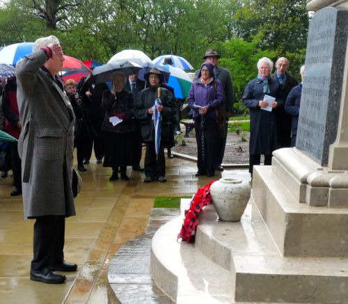 John Pritchard saluting the dead of two World Wars, after laying a wreath on behalf of the town