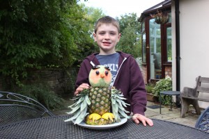 My owl: Harry Stevenson, with his prizewinning figure made mostly from pineapple 